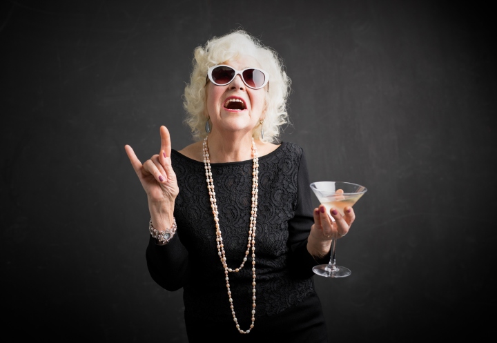Cool grandmother with sunglasses and drink in hand